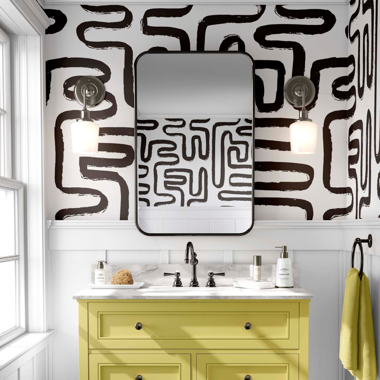 black and white maze wallpaper in a powder room with a yellow vanity