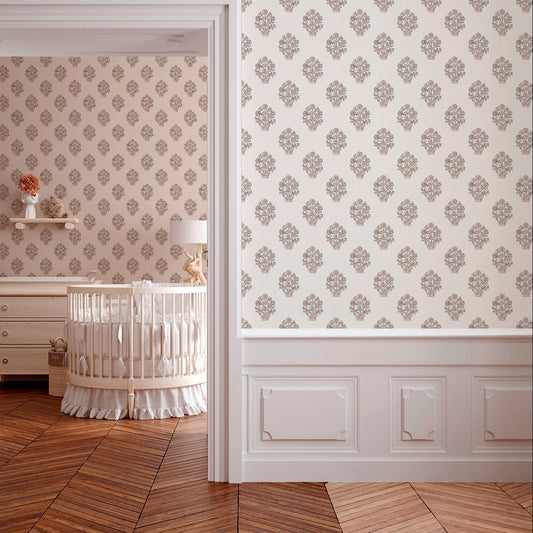 A serene nursery featuring floral patterned wallpaper, a wooden crib, and a light lamp. The room has warm wooden flooring and a cozy ambiance.