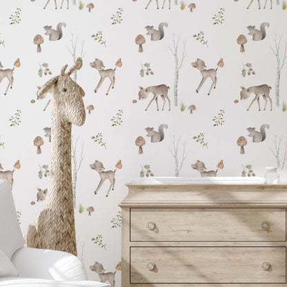 A cottagecore nursery bedroom featuring wallpaper with watercolor pastel deer, squirl and mushrooms.