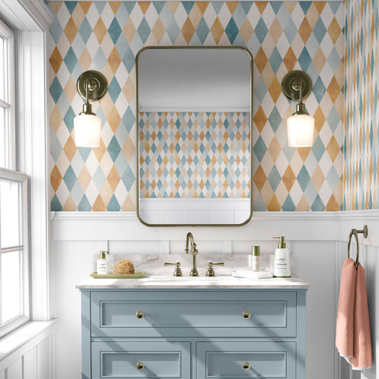 cat-610804236616 Harlequin pattern wallpaper featuring a watercolor diamond design in teal, ochre, and cream tones installed in a modern bathroom with a blue vanity and brass fixtures.