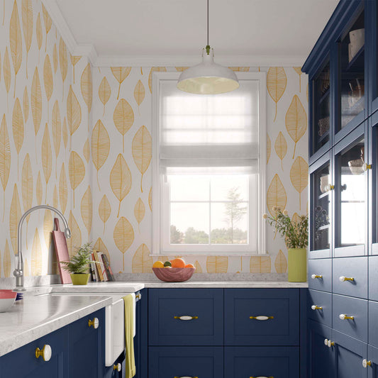 cat-615198490952 Modern kitchen interior featuring a vibrant yellow leaf wallpaper with a delicate linear pattern, styled with bold navy blue cabinetry, white marble countertops, and a white pendant light.