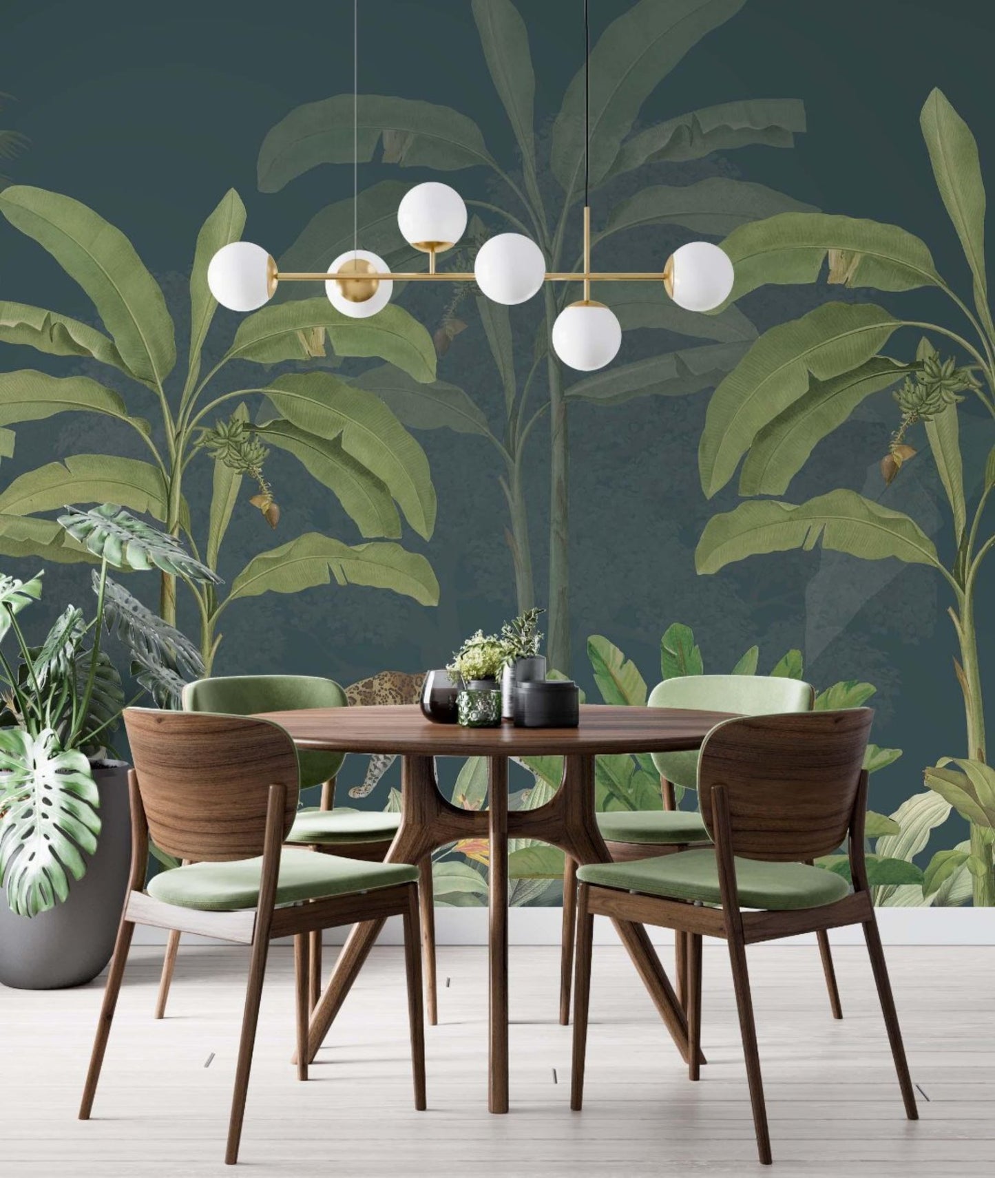 A dining room featuring a green wall mural  adorned with a large tropical plants, creating a vibrant and inviting atmosphere.