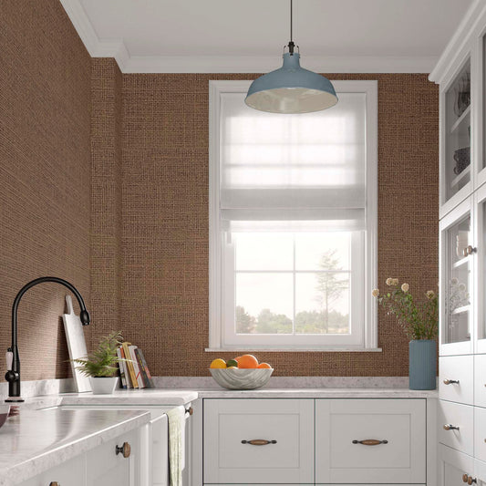 cat-615198490952 Modern rustic kitchen featuring a focal wall with tobacco brown grasscloth-textured wallpaper. The faux burlap pattern adds a rich, organic weave that contrasts with the silk-white Shaker cabinets and a white marble countertop.