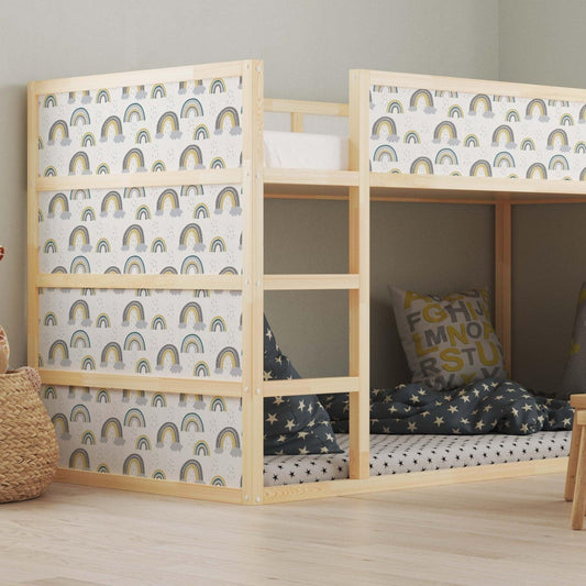 Kura bed with colorful rainbow decals in a children's bedroom, featuring cozy bedding, decorative pillows, and a small wooden table with chairs.