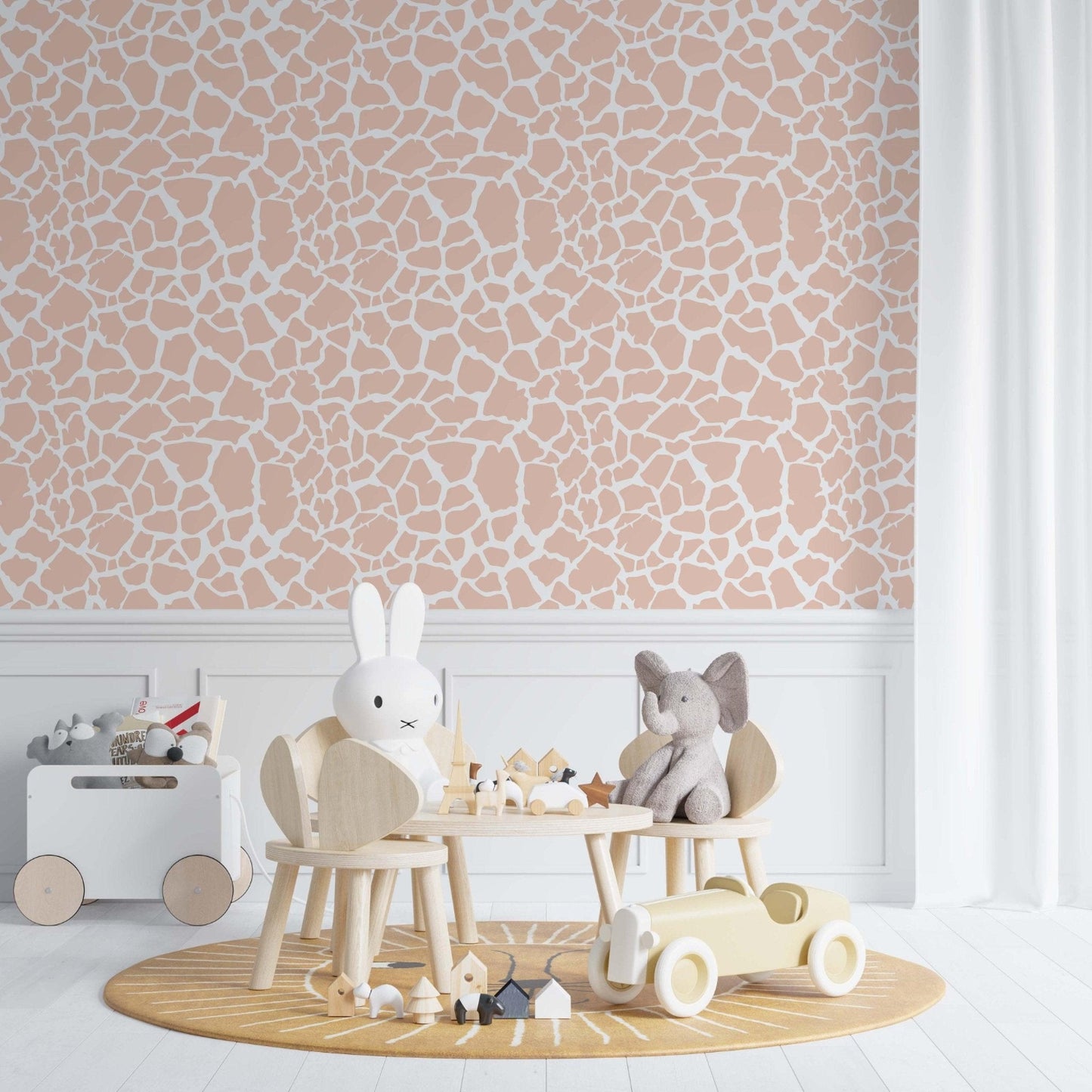 Pink Giraffe Pattern wallpaper in a classic kids bedroom featuring a white wainscot.