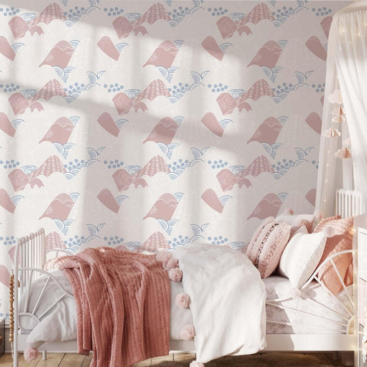 A sweet, feminine children’s bedroom with a white metal bed topped with pink, fluffy bedding. The wallpaper showcases a mountain design in soft pinks and blues, while a sheer canopy draped with string lights adds a magical touch. A glowing star-shaped lamp and soft toys enhance the room’s warm, inviting atmosphere.