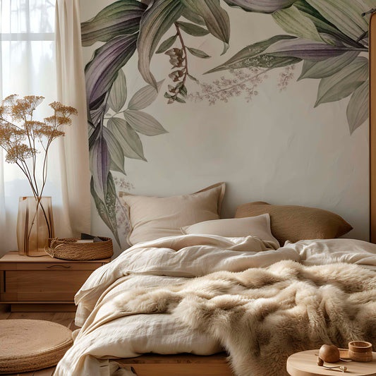 cat-610567389512 Botanical wallpaper mural with green and purple leaves above a bed with linen bedding, wood nightstand and dried flowers in a warm neutral bedroom