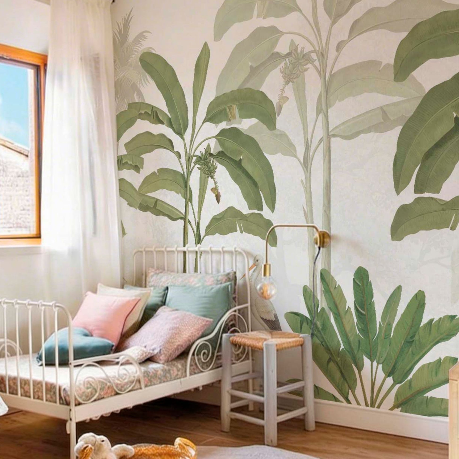 cat-661212758344 Storks in the Jungle wallpaper mural in a children's bedroom with banana leaf motif in soft sage green and warm beige