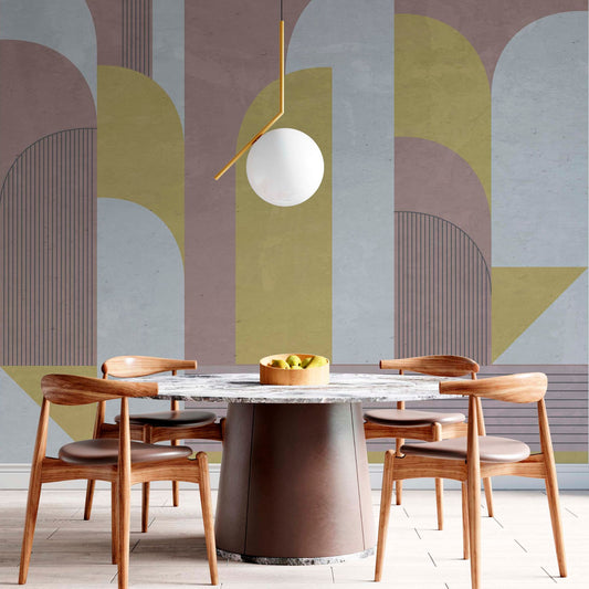 cat-610512830792 Abstract Bauhaus-inspired wallpaper mural with large textured geometric arches in mustard, dusty pink, and grey, styled in a modern dining room with a marble table and wooden chairs.