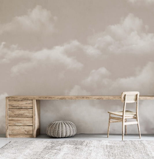 An inviting room with a wooden desk and a stunning mural of clouds adorning the wall.