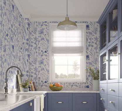 cat-615198490952 kitchen-wallpaper featuring floral design in blue and white shades. Country style kitchen with purple cabinets, marble countertop, light fixture and window with sheer blinds.