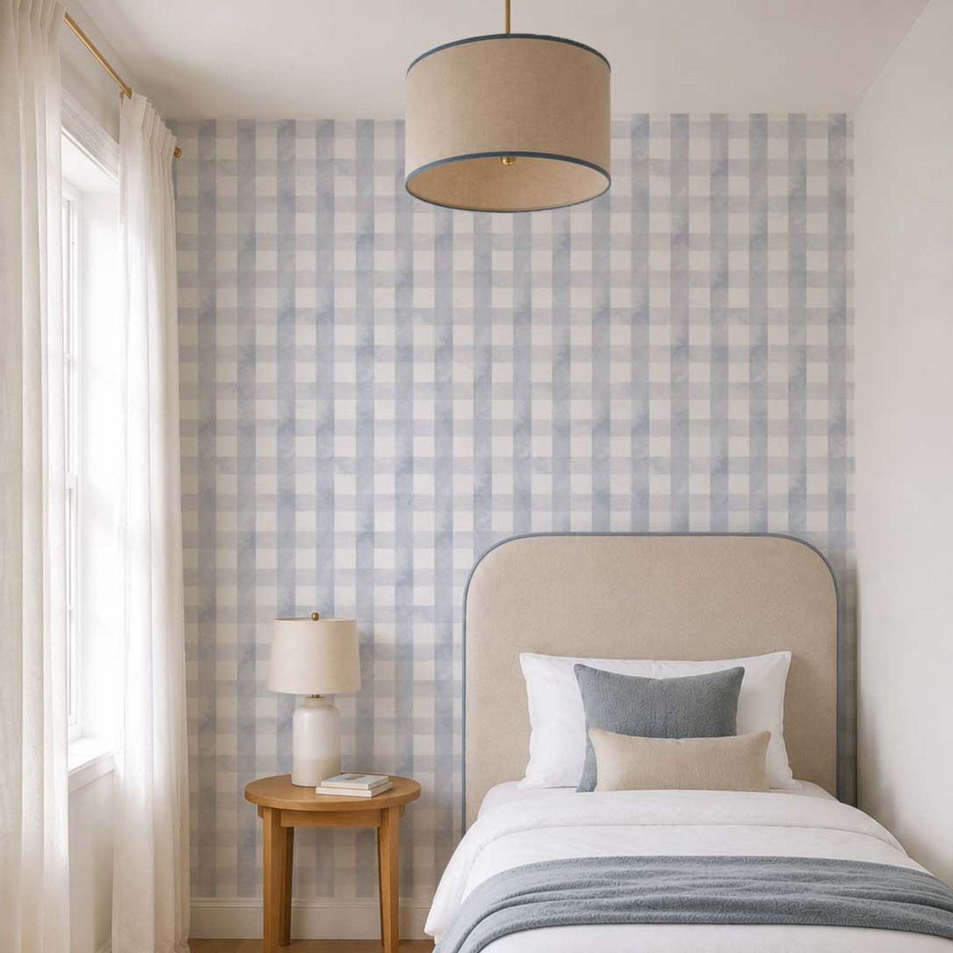 cat-615198294344 Blue grey gingham wallpaper in a bright children's bedroom with an upholstered single bed, light oak furniture and soft neutral textiles.