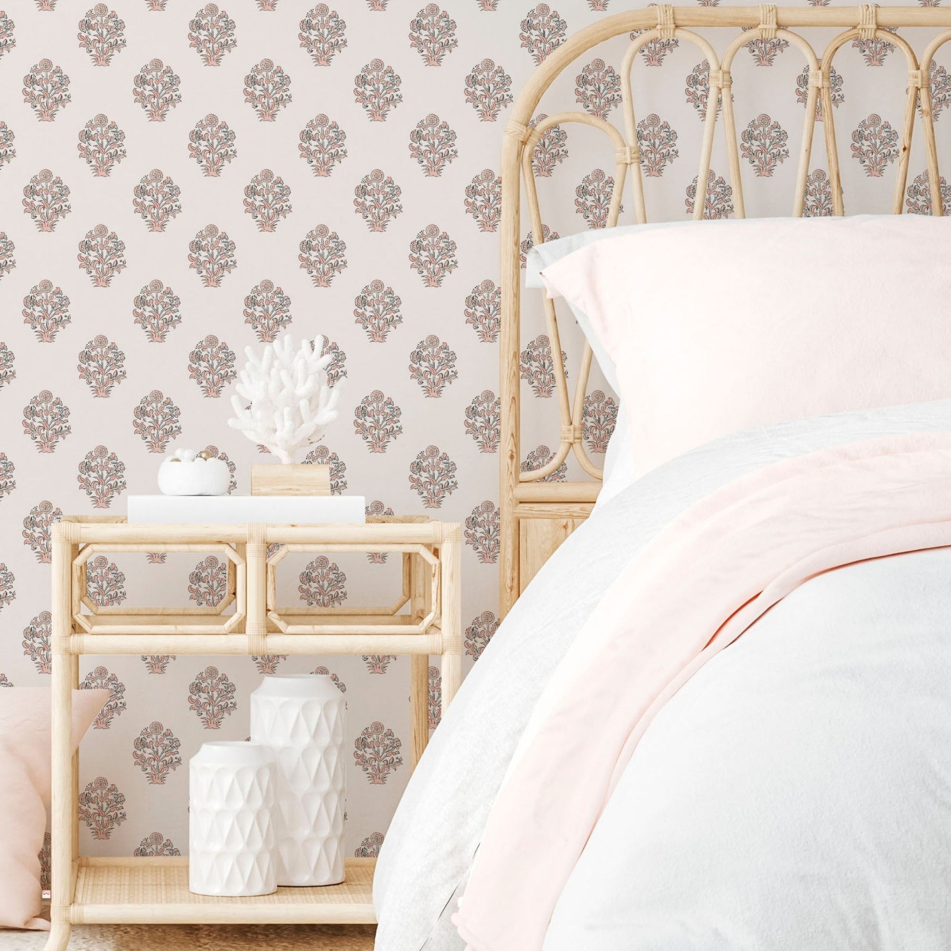 cat-616983200072 A bohemian-style bedroom featuring a rust-colored floral crest wallpaper, a natural rattan arched headboard, and a matching cane nightstand with neutral bedding.