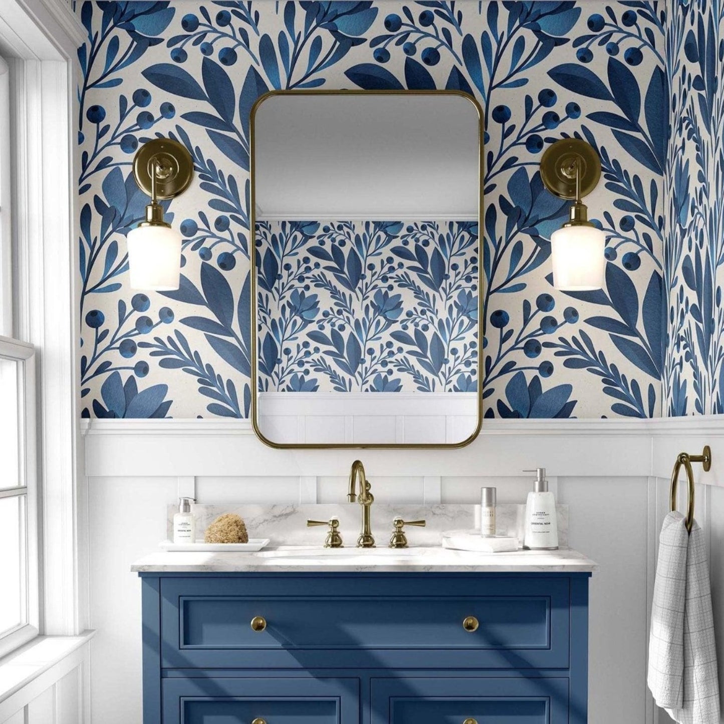 Elegant bathroom adorned with a bright blue and white leaves wallpaper, showcasing a chic bright blue vanity.