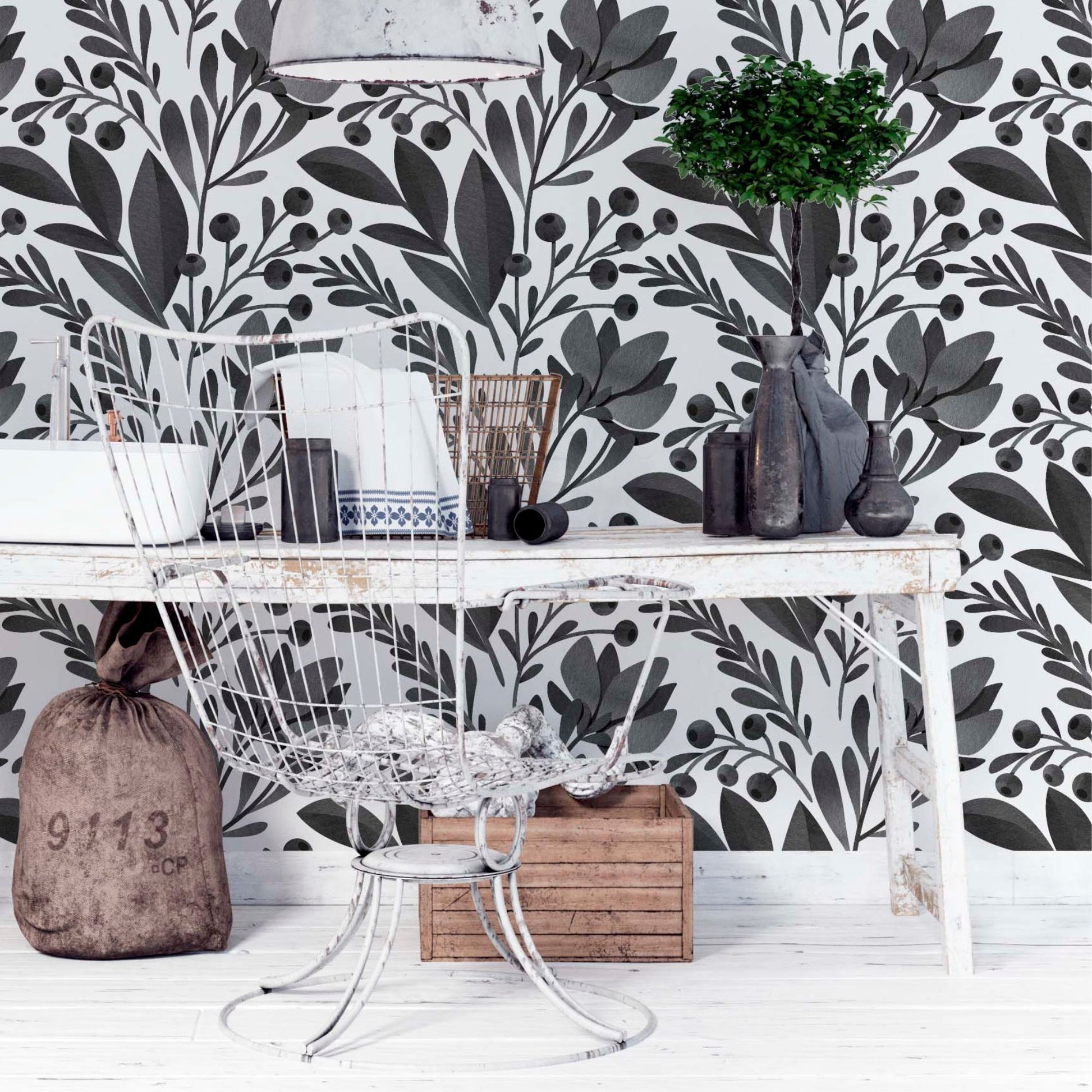 at-610804433224 Dark charcoal botanical leaf and berry pattern on a white background in a studio setting with metal and rustic wood furniture.