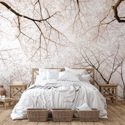 Cherry blossom wall mural with delicate sakura branches decorating a calm Japandi style bedroom.