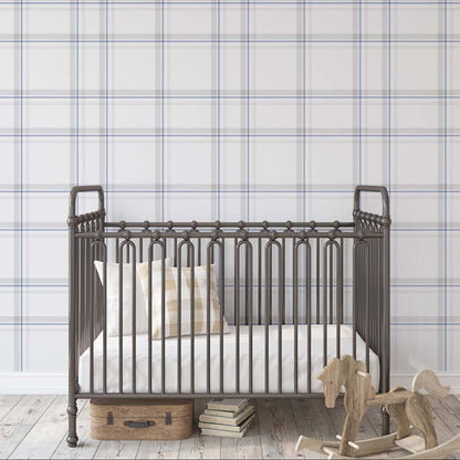 Timeless blue and gray plaid tartan wallpaper in a classic nursery room with a vintage metal crib and wooden rocking horse.