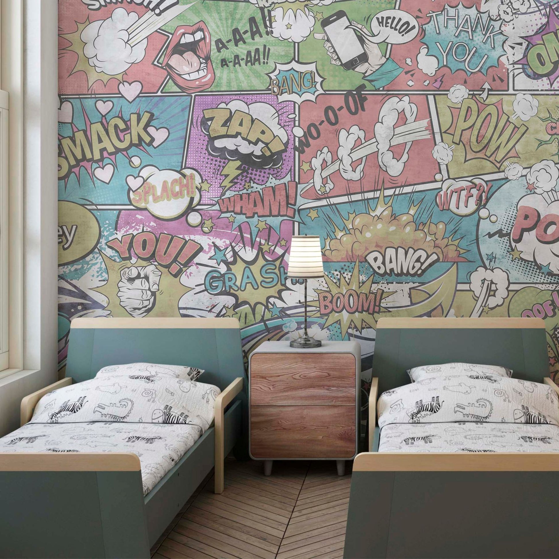 A children's bedroom featuring twin beds with teal headboards and a comic book-style mural background with colorful action bubbles and sound effects.