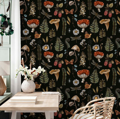 cat-610804433224 A sophisticated home office showcasing an atmospheric botanical wallpaper with vintage-style illustrations of mushrooms and forest wildlife. The dark, intricate pattern creates a striking backdrop for a minimalist wooden desk and a woven rattan chair, blending natural textures with a scholarly, antique aesthetic.