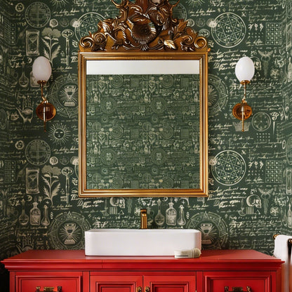 cat-610804236616 Dark green bathroom with vintage botanical and alchemy-themed wallpaper, a gold-framed mirror, and a red vanity.