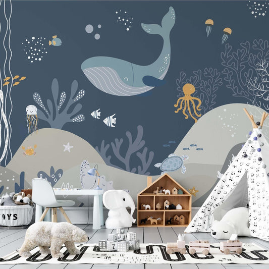Blue whale and sea creatures wallpaper mural in a kids' playroom with a white teepee and toys.
