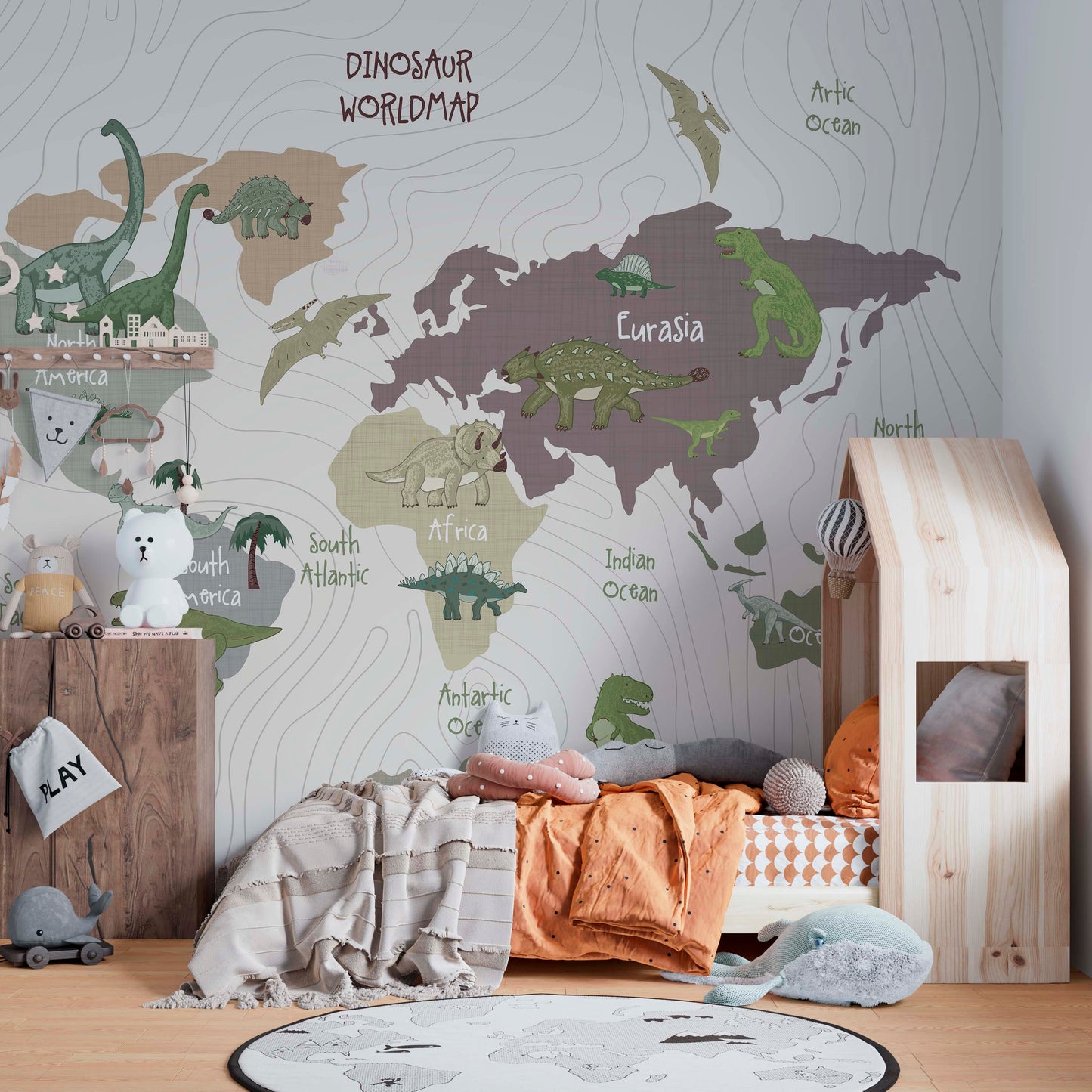  A cozy children's bedroom featuring a large "Dinosaur Worldmap" wall mural, a house-shaped wooden floor bed with orange and grey bedding, and a collection of plush animal toys and a whale-shaped rug.