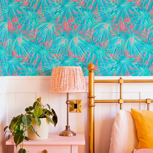cat-616983200072 Eclectic bedroom with coral and teal tropical wallpaper, a pink nightstand, and a gold bed frame.