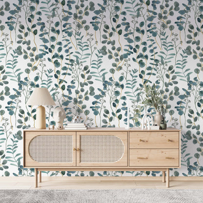  cat- 659356549448A bright living space featuring a teal and white botanical wallpaper with watercolor eucalyptus leaves. A modern light wood sideboard with rattan doors is centered against the accent wall, decorated with a pleated table lamp, minimalist sculptures, and a vase with greenery. The room has a clean, Scandinavian-inspired aesthetic with light flooring and a textured gray rug.
