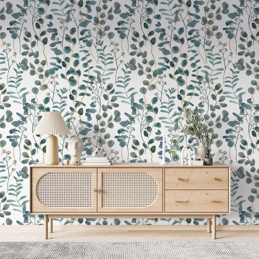  cat-659356549448 A bright living space featuring a teal and white botanical wallpaper with watercolor eucalyptus leaves. A modern light wood sideboard with rattan doors is centered against the accent wall, decorated with a pleated table lamp, minimalist sculptures, and a vase with greenery. The room has a clean, Scandinavian-inspired aesthetic with light flooring and a textured gray rug.
