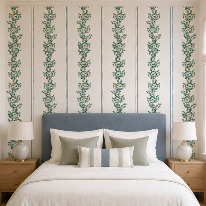cat-616983200072 Blue and green striped eucalyptus wallpaper behind a bed with a blue upholstered headboard