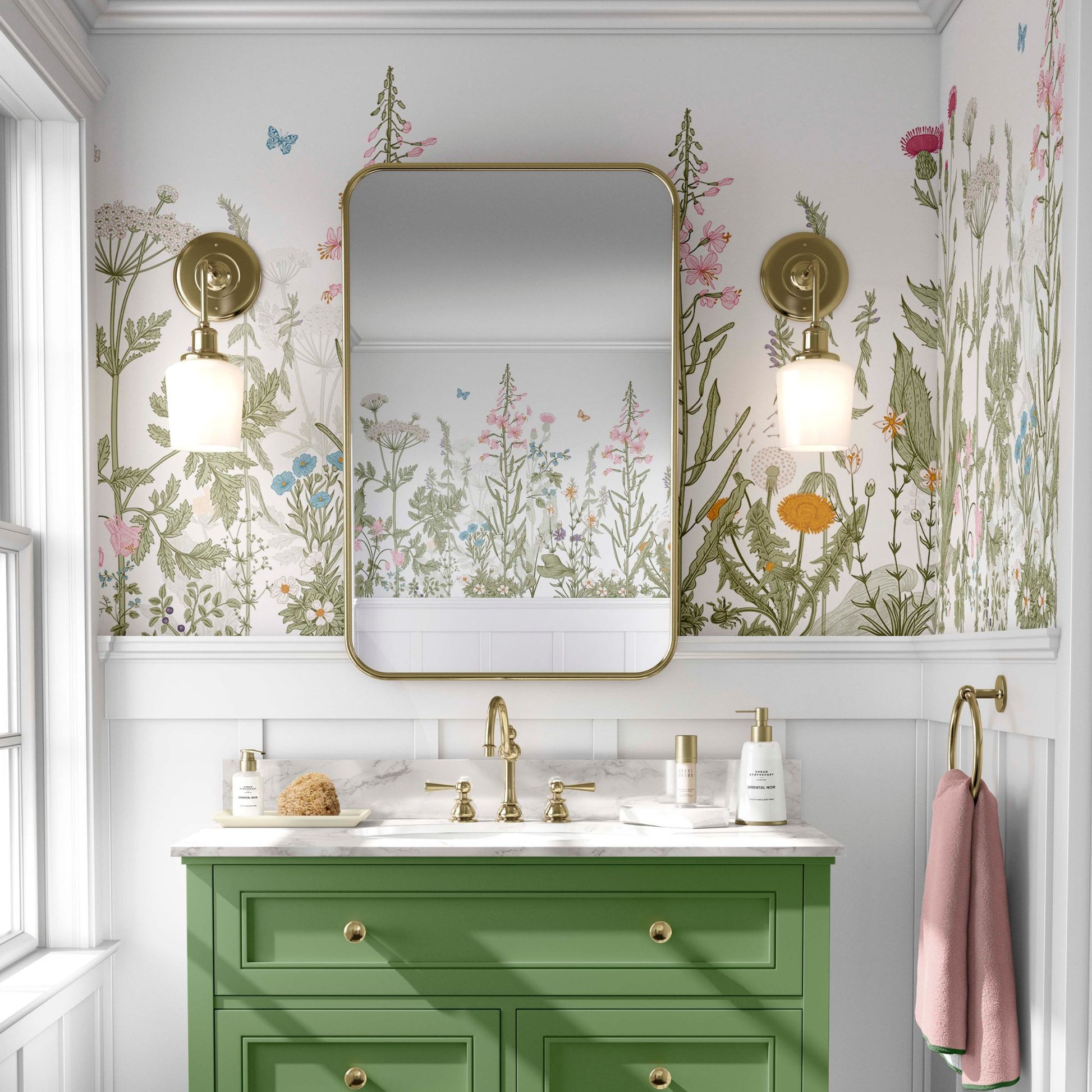 cat-610804236616 Elegant bathroom featuring wildflower botanical wallpaper above white wainscoting, a green vanity with gold hardware, and a large rectangular gold mirror.