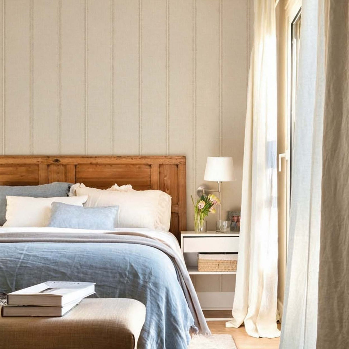 cat-616983200072 Bedroom with beige striped wallpaper behind a rustic wooden headboard and blue linen bedding