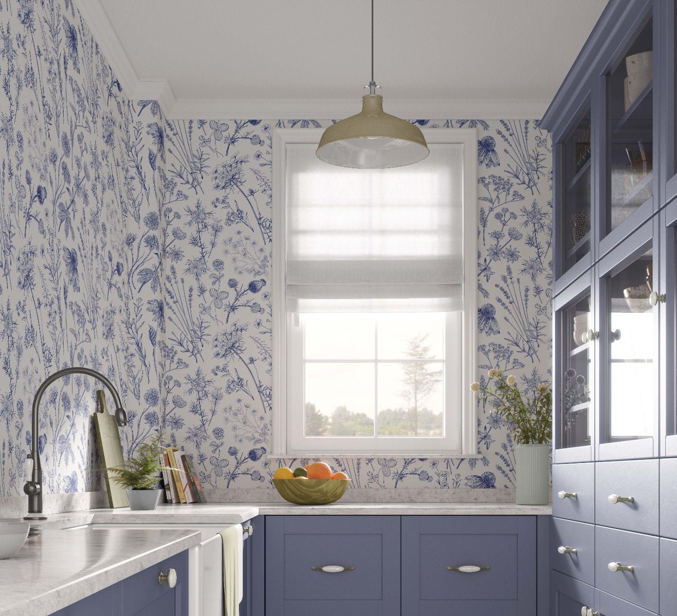 Wallpaper featuring a floral design in shades of blue and white adorns the walls of a country style kitchen, complemented by a light fixture and a window with sheer blinds. The kitchen includes purple cabinets, a marble countertop, and a bowl of colorful fruit on display.