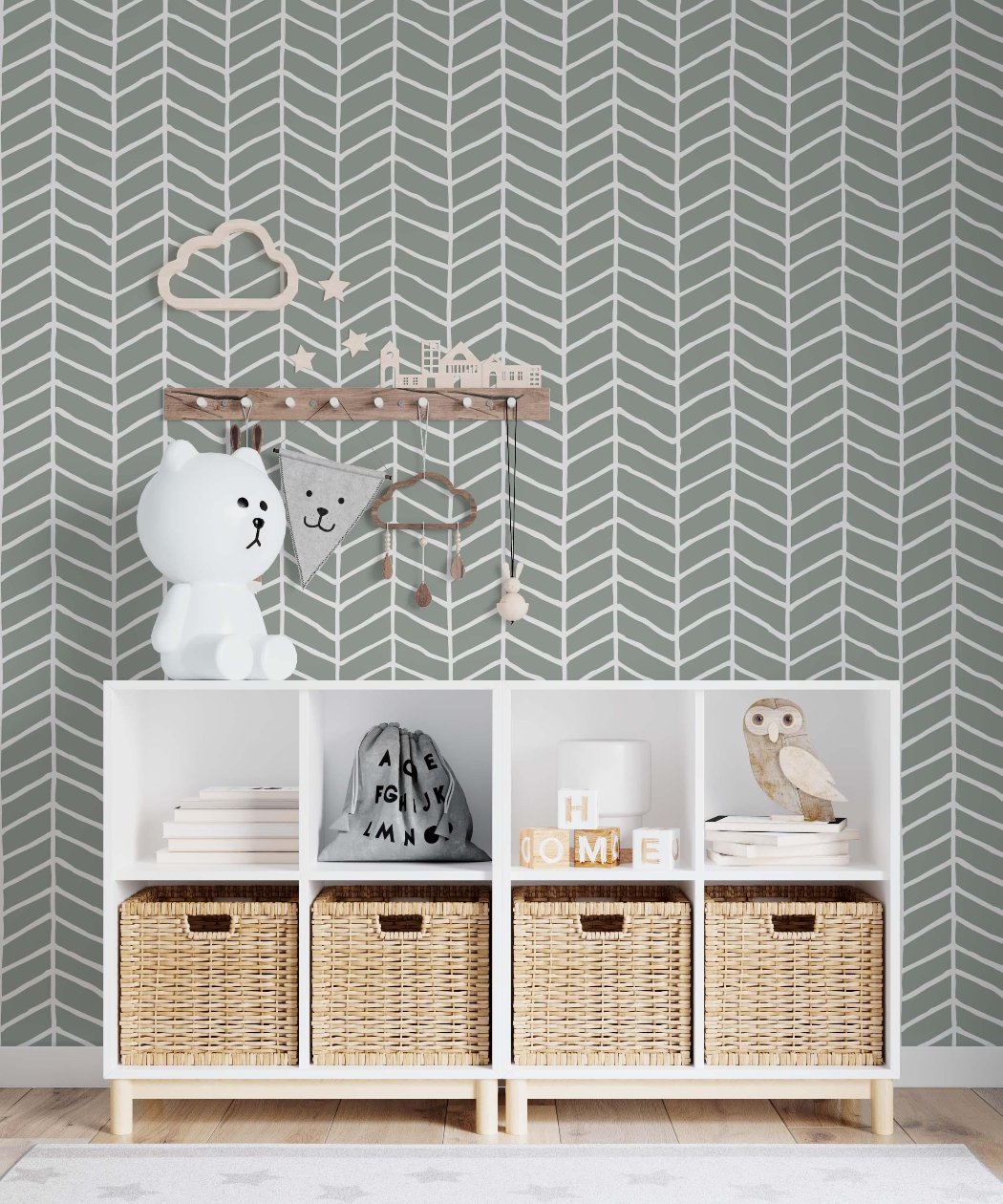 A charming nursery adorned with grey and white chevron wallpaper, providing a soothing and contemporary environment for a baby.