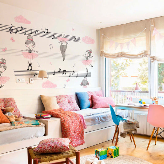 Girl’s bedroom with a large musical mural featuring ballerinas and music notes on a white wall.