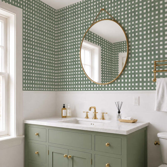 cat-610804236616 Small bathroom with muted green checkered wallpaper, sage green vanity, brass fixtures and white subway tile.