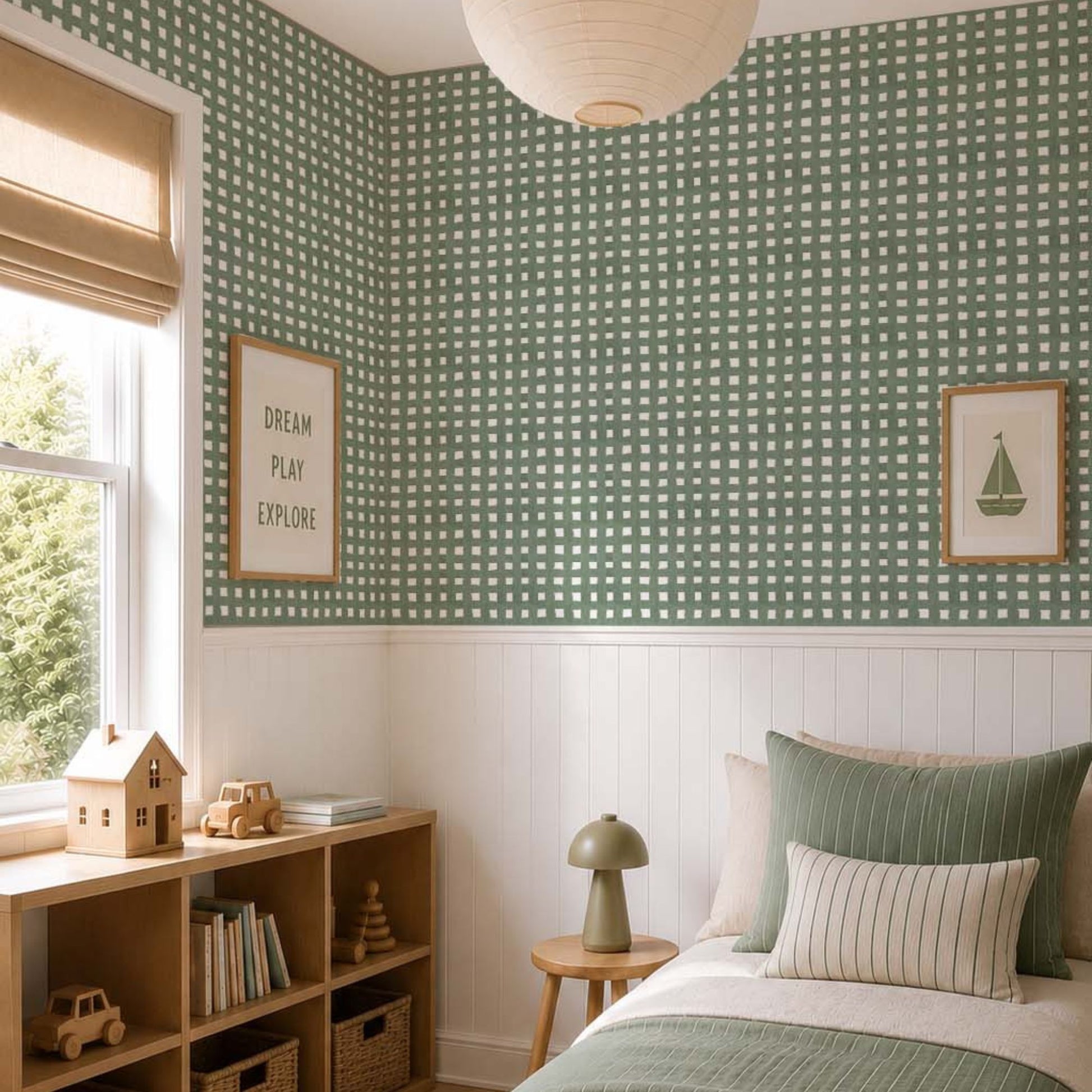 cat-615198294344 Scandinavian kids bedroom with sage green checkered wallpaper, white wainscoting, light oak furniture and olive green striped bedding.