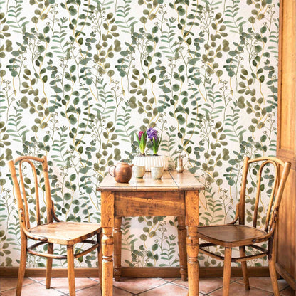 cat- 659356549448 Rustic dining nook featuring green eucalyptus watercolor wallpaper, a vintage wooden table, and two classic wooden chairs.
