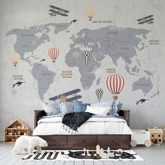 cat-610568044872 Grey world map wallpaper mural with hot air balloons and vintage planes in a kids bedroom with dark wood bed and wooden toys