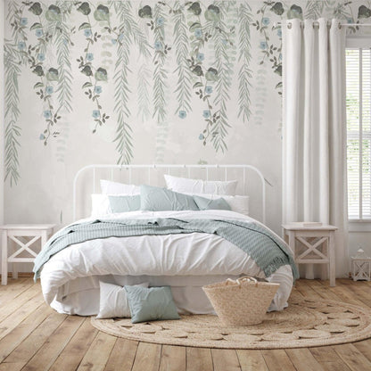 A cozy bedroom featuring a white bed against a backdrop of vibrant green floral wallpaper.