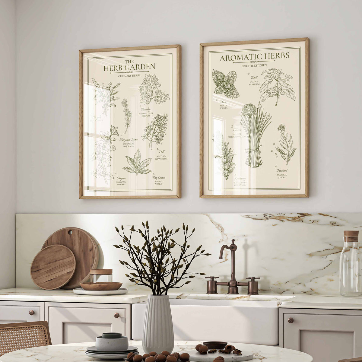 Two vintage herb prints framed in oak above a marble kitchen counter and dining table