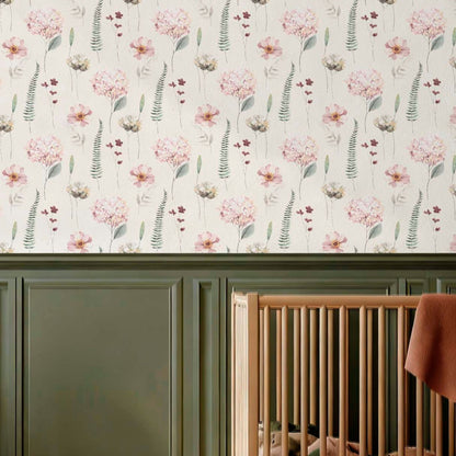 cat-615198294344 A modern nursery corner featuring a natural wood crib, deep green wall paneling, and delicate floral hydrangea wallpaper in pink and green tones.