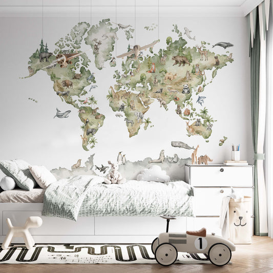 cat-661212758344 Gender-neutral world map wallpaper with safari and arctic animals on a kids' bedroom wall behind a white bed with a classic toy ride-on car.