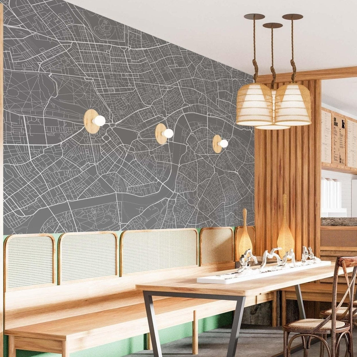 cat-610512830792 London street map mural wallpaper in dark grey and white in a dining room with wooden table, rattan chairs and pendant lights