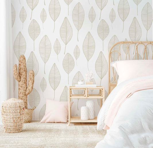 cat-616983200072 Bright bedroom featuring a minimalist beige leaf wallpaper with a delicate linear pattern, styled with a rattan bed frame, a matching nightstand, and soft blush pink textiles.