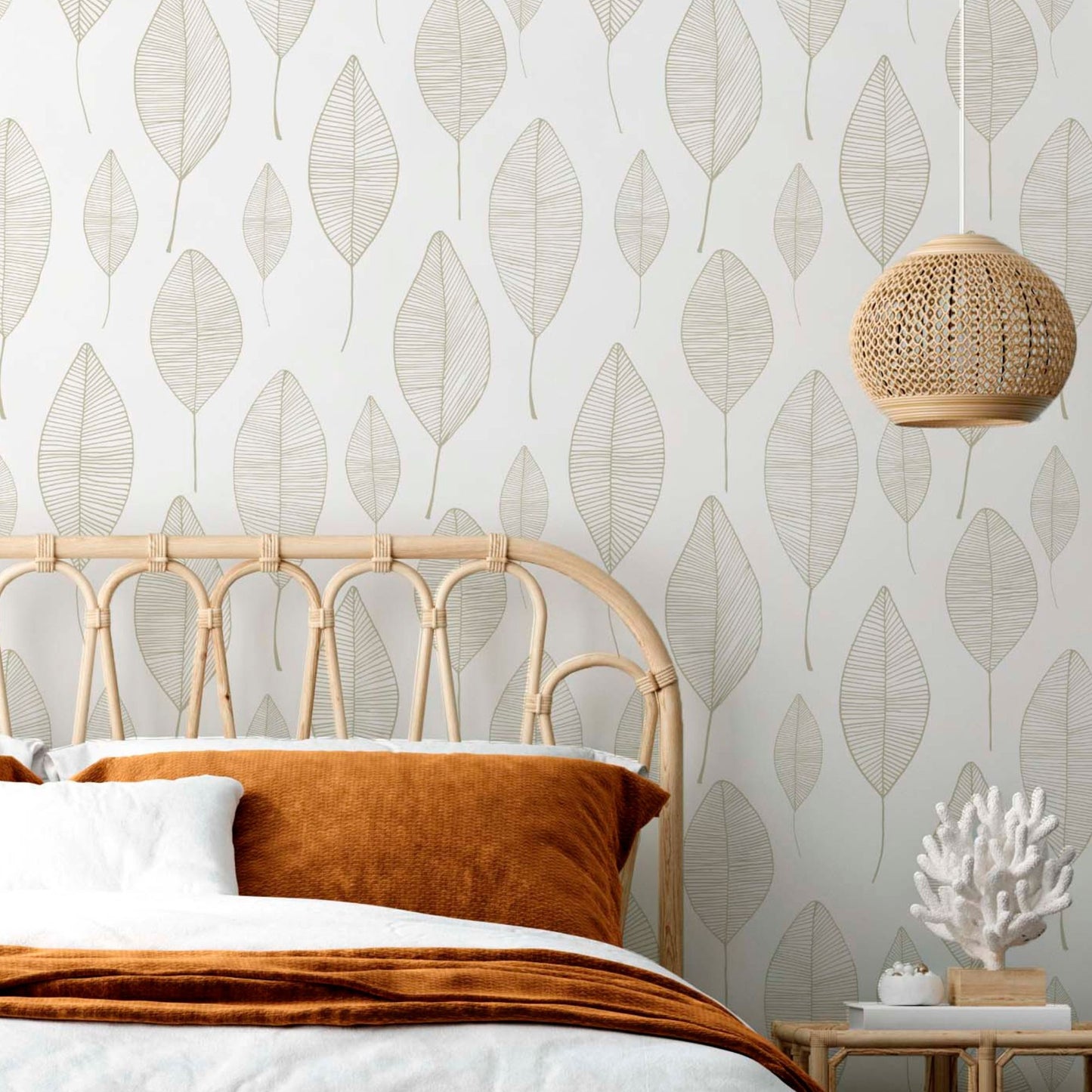 cat-616983200072 Bright bedroom featuring a minimalist beige leaf wallpaper with a delicate linear pattern, styled with a rattan bed frame, a matching nightstand, and soft blush pink textiles.
