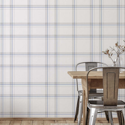 cat- 659356549448 Modern Charter Plaid wallpaper with thin blue and grey lines on an off-white background, styled in a contemporary dining room with wooden floors and metal chairs.