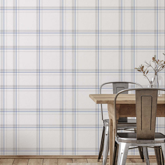 cat-615198490952 Modern Charter Plaid wallpaper with thin blue and grey lines on an off-white background, styled in a contemporary dining room with wooden floors and metal chairs.