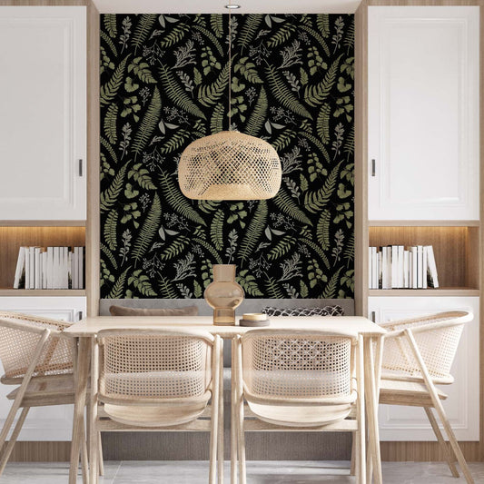 Modern dining room featuring an accent wall with black and green fern wallpaper, a light wood table with four woven rattan chairs, a wicker pendant light, and white built-in cabinets with integrated bookshelves.