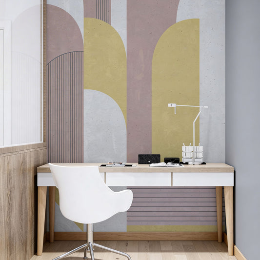 cat-660961526088 Abstract wallpaper mural with geometric arches in mustard, dusty pink, and grey tones, installed behind a white desk in a modern home office workspace.
